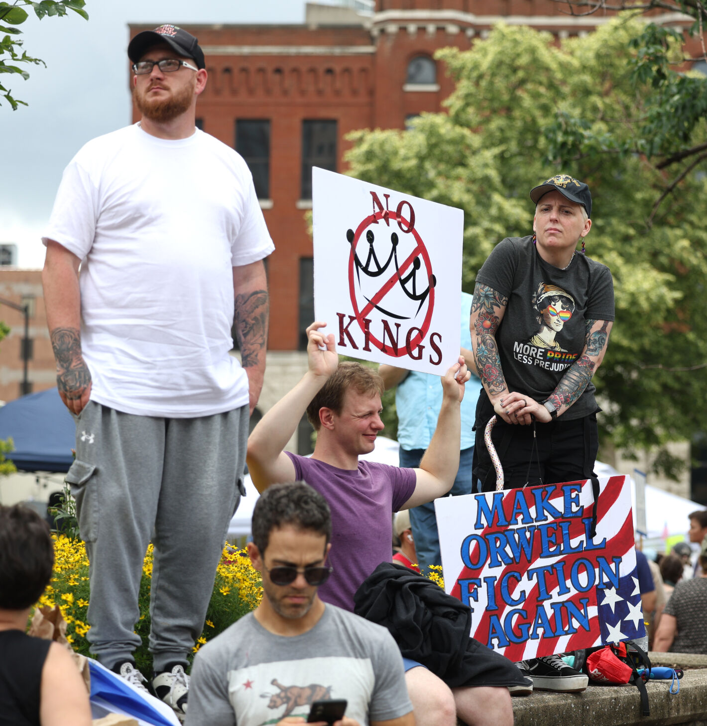 People stand with sign near Metro Hall.JPG